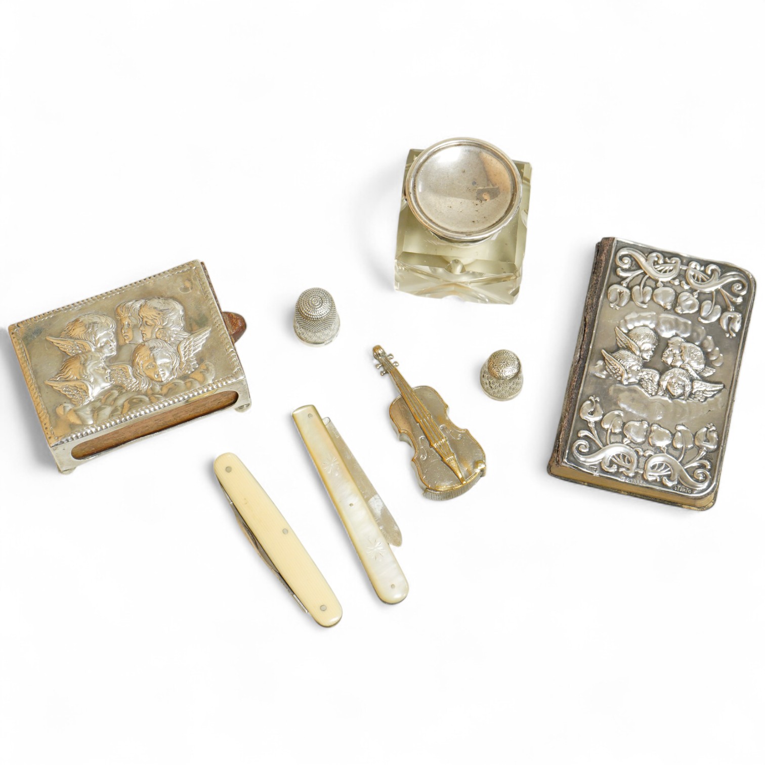 A small group of silver and other items, including an Edwardian silver mounted Common Prayer book(a.f.), a silver mounted matches holder, a silver mounted glass inkwell, a silver and mother of pearl fruit knife, two thim